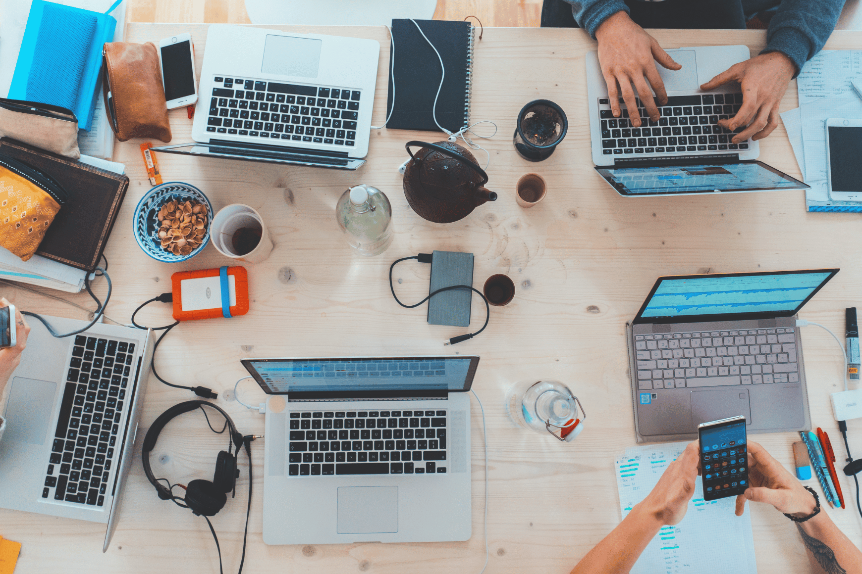 Business team work around laptops on desk
